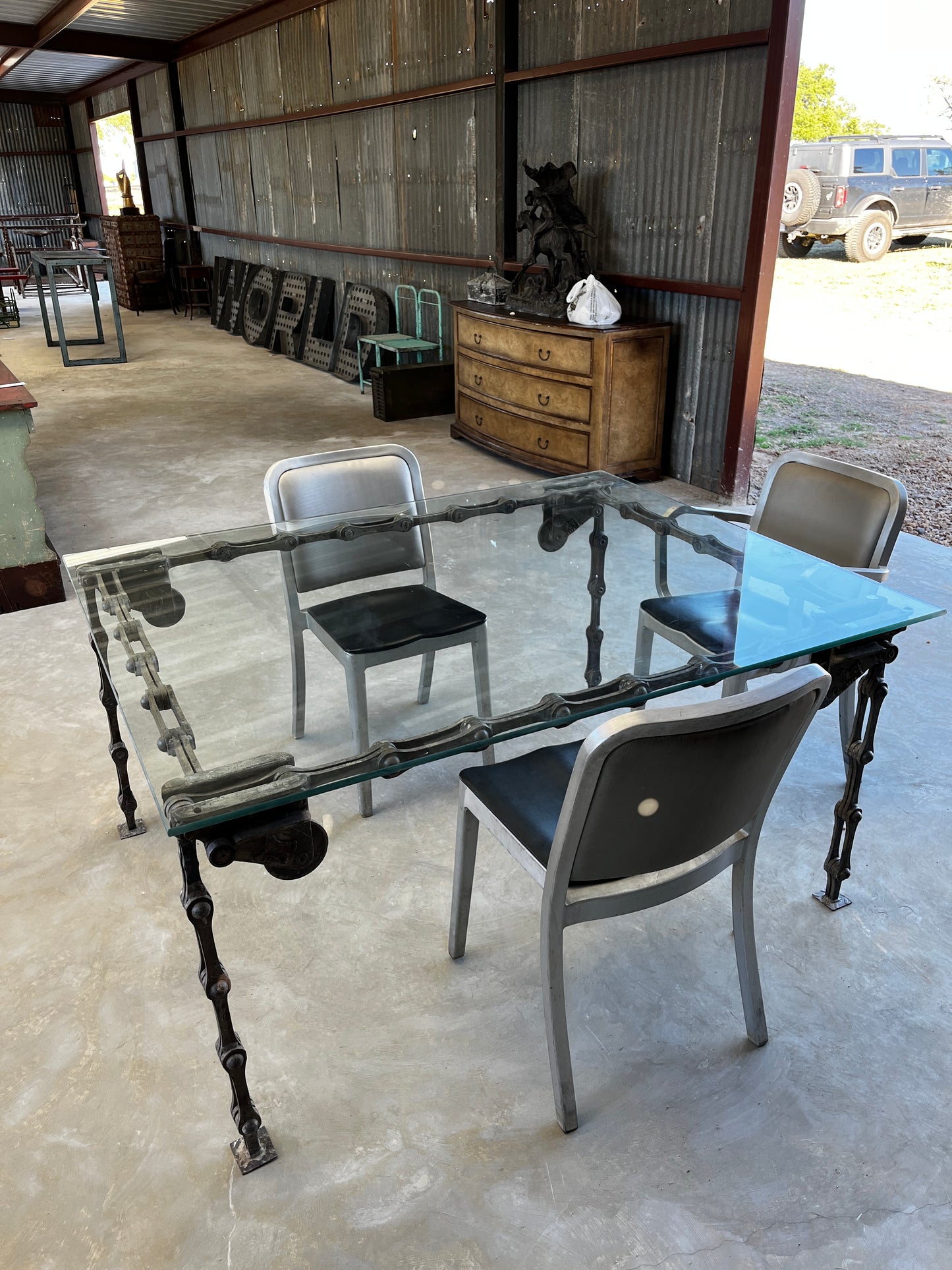 Steel “chain link” table with glass top